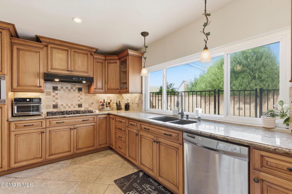 1837 Marcella Street Simi Valley, CA 93065 - Photo 15 of 66 a kitchen with granite countertop a sink window and cabinets