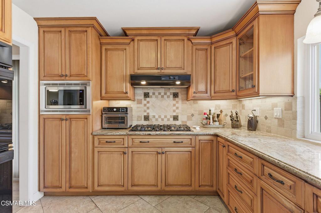 1837 Marcella Street Simi Valley, CA 93065 - Photo 19 of 66 a kitchen with stainless steel appliances granite countertop a stove and cabinets