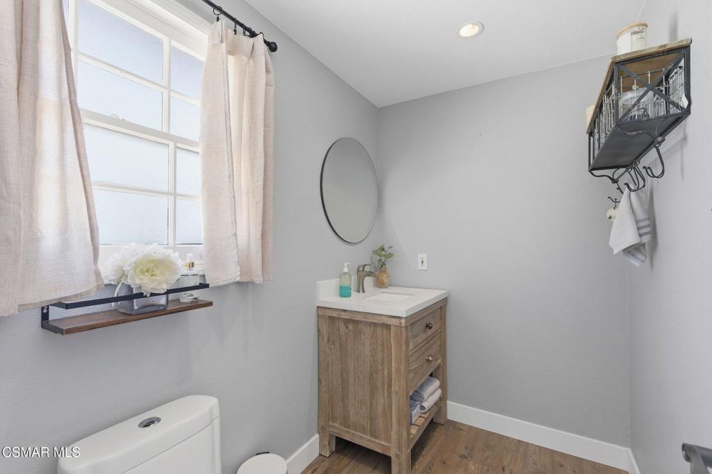 1837 Marcella Street Simi Valley, CA 93065 - Photo 28 of 66 a bathroom with a sink a light fixture and a toilet