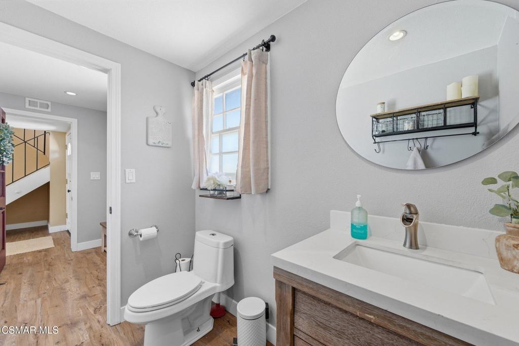 1837 Marcella Street Simi Valley, CA 93065 - Photo 29 of 66 a bathroom with a toilet a sink and a mirror