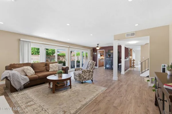 a living room with furniture a large window and a fireplace