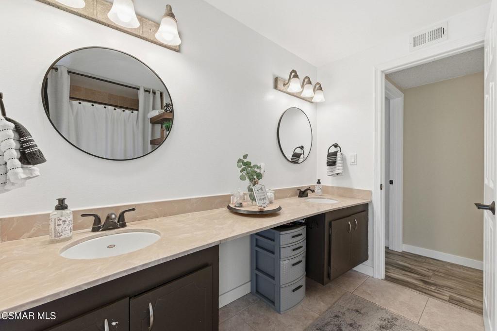 1837 Marcella Street Simi Valley, CA 93065 - Photo 44 of 66 a bathroom with a double vanity sink and a mirror