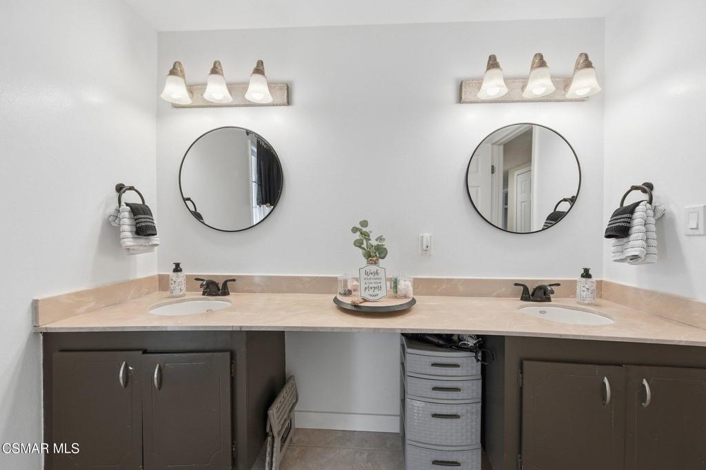 1837 Marcella Street Simi Valley, CA 93065 - Photo 45 of 66 a bathroom with a double vanity sink and a mirror