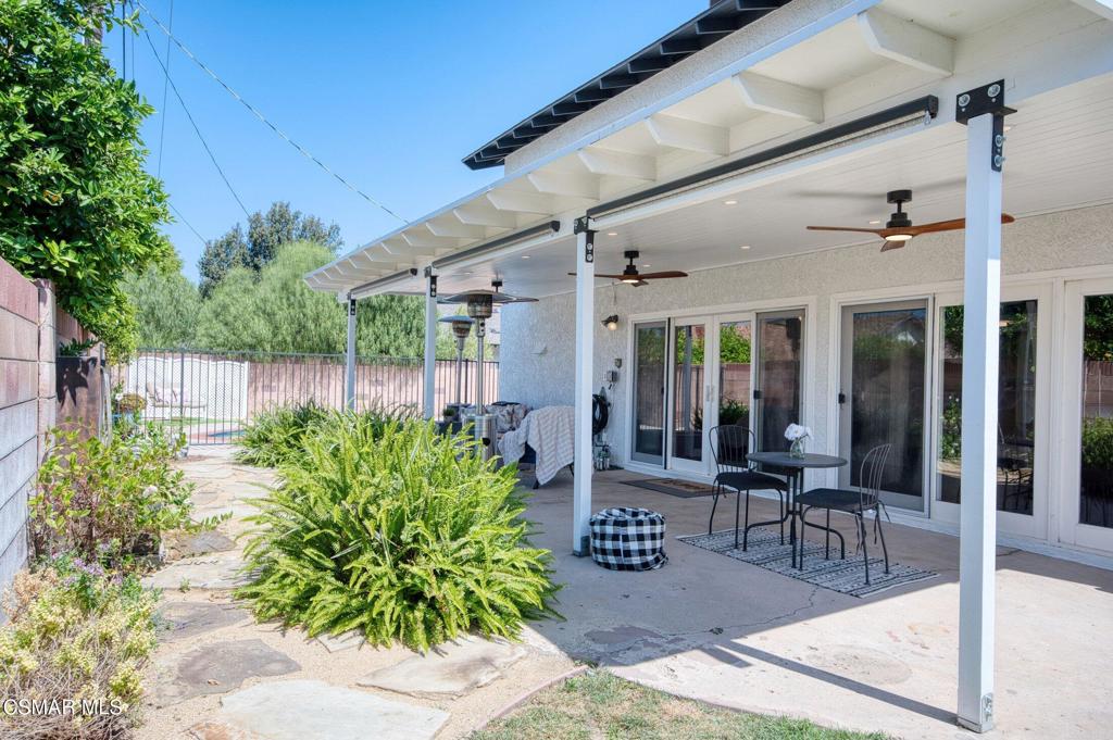 1837 Marcella Street Simi Valley, CA 93065 - Photo 59 of 66 a view of a patio with table and chairs potted plants and floor to ceiling window