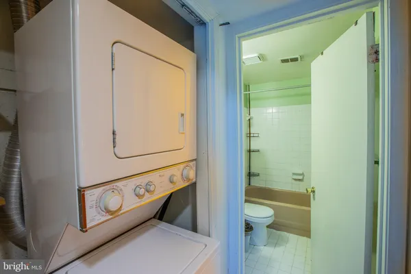 a bathroom with a granite countertop tub sink and mirror