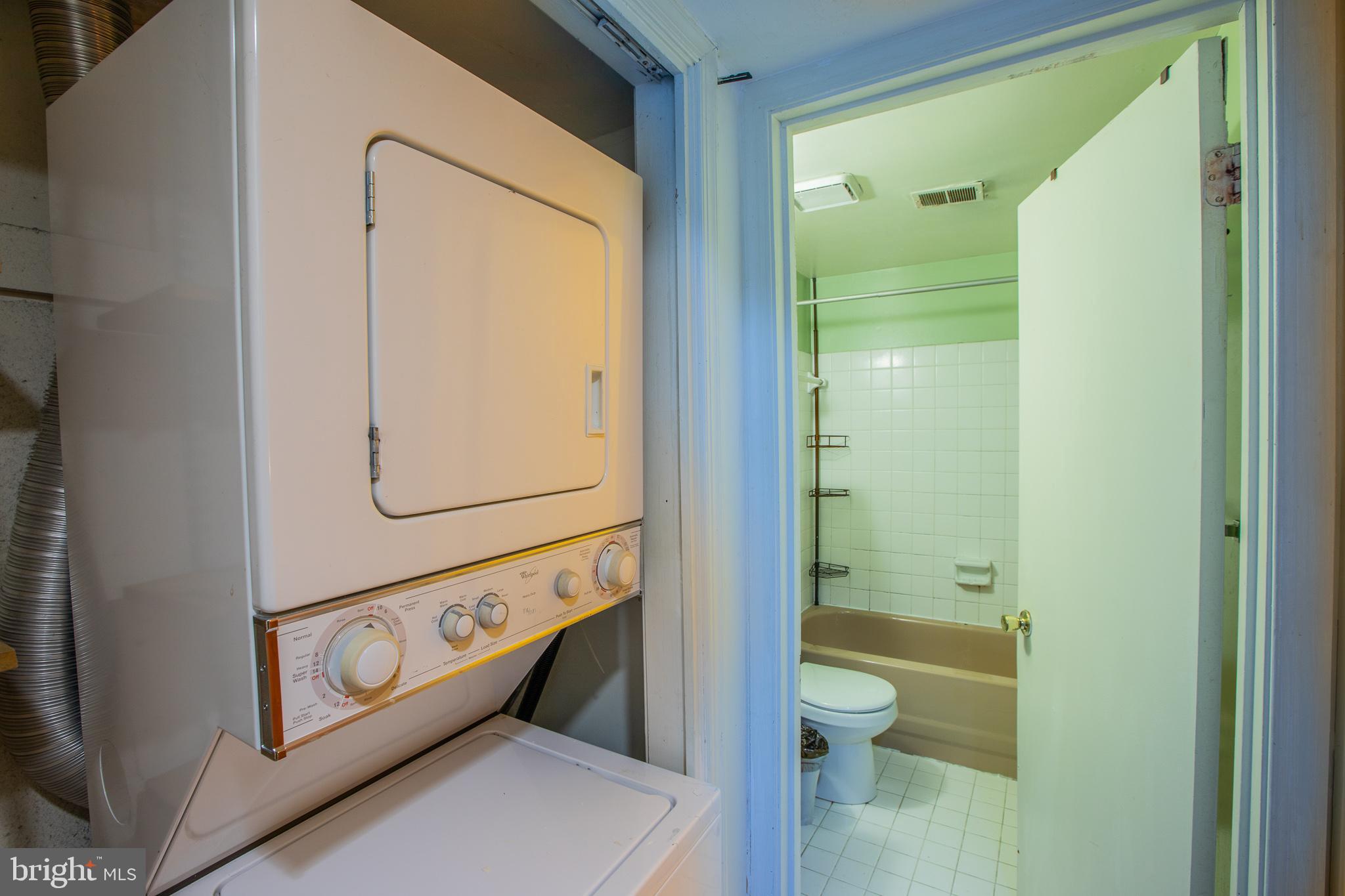 909 R Street Northwest, Unit B Washington, DC 20001 - Photo 16 of 17 a bathroom with a granite countertop tub sink and mirror