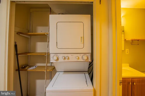 a bathroom with a sink and mirror with bathtub