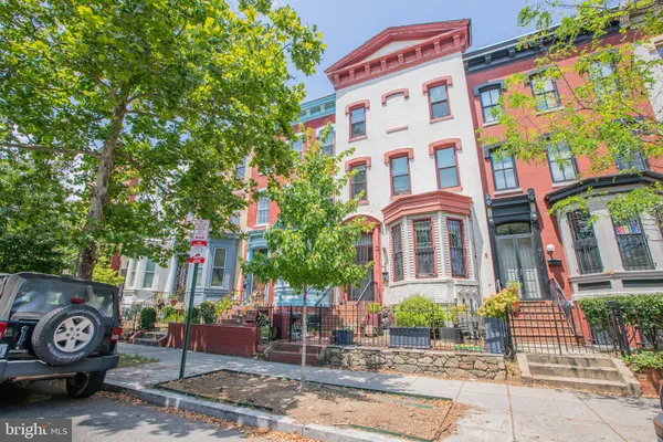 a front view of a building with tree s