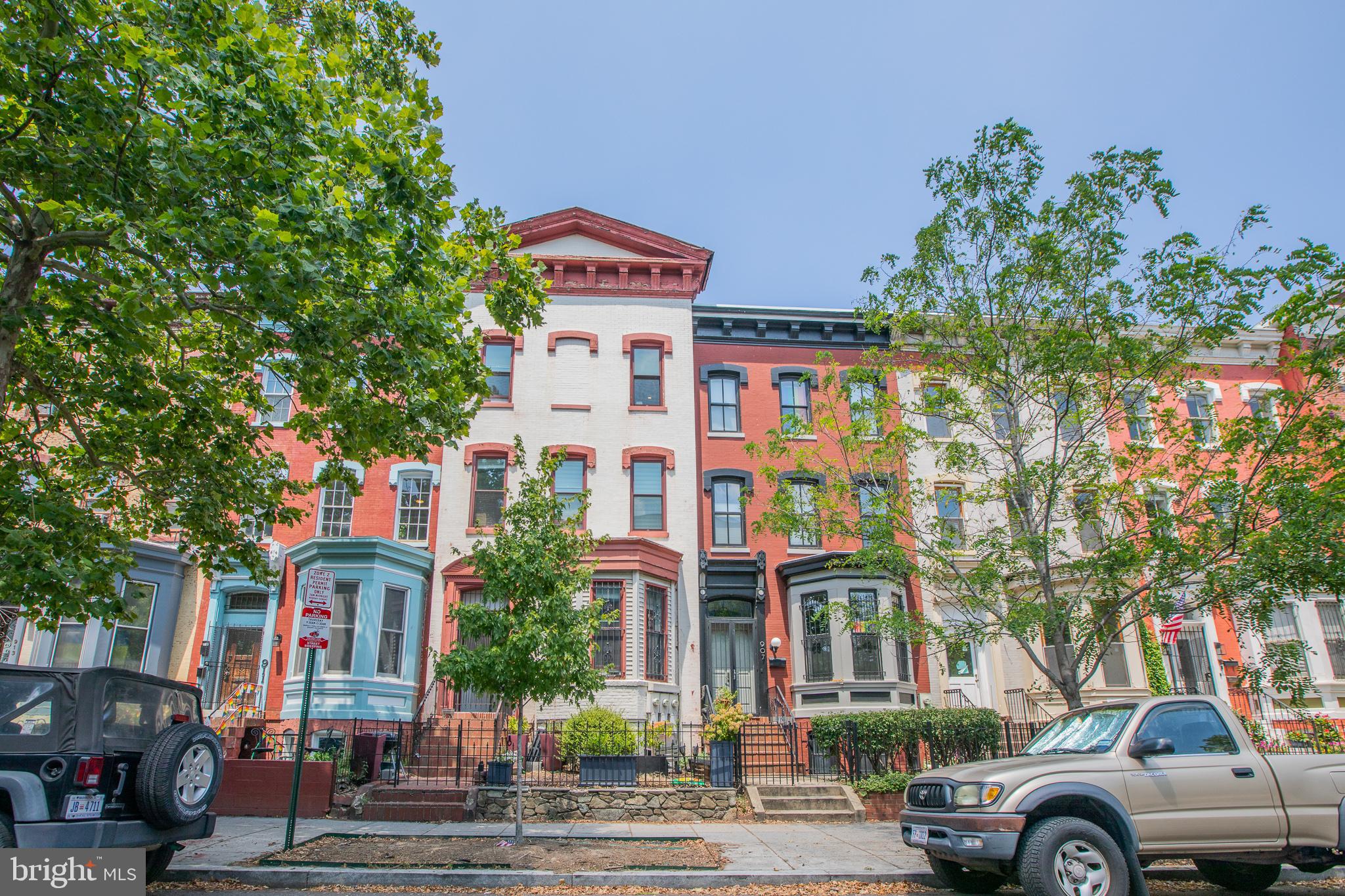 909 R Street Northwest, Unit B Washington, DC 20001 - Photo 3 of 17 a front view of a building with lot of cars and trees