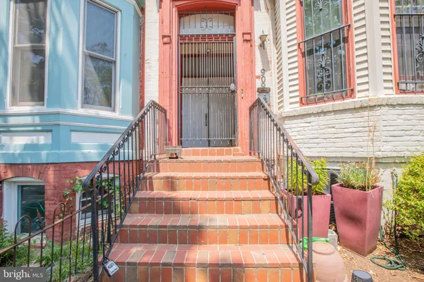 a view of a building with a potted plant and stairs