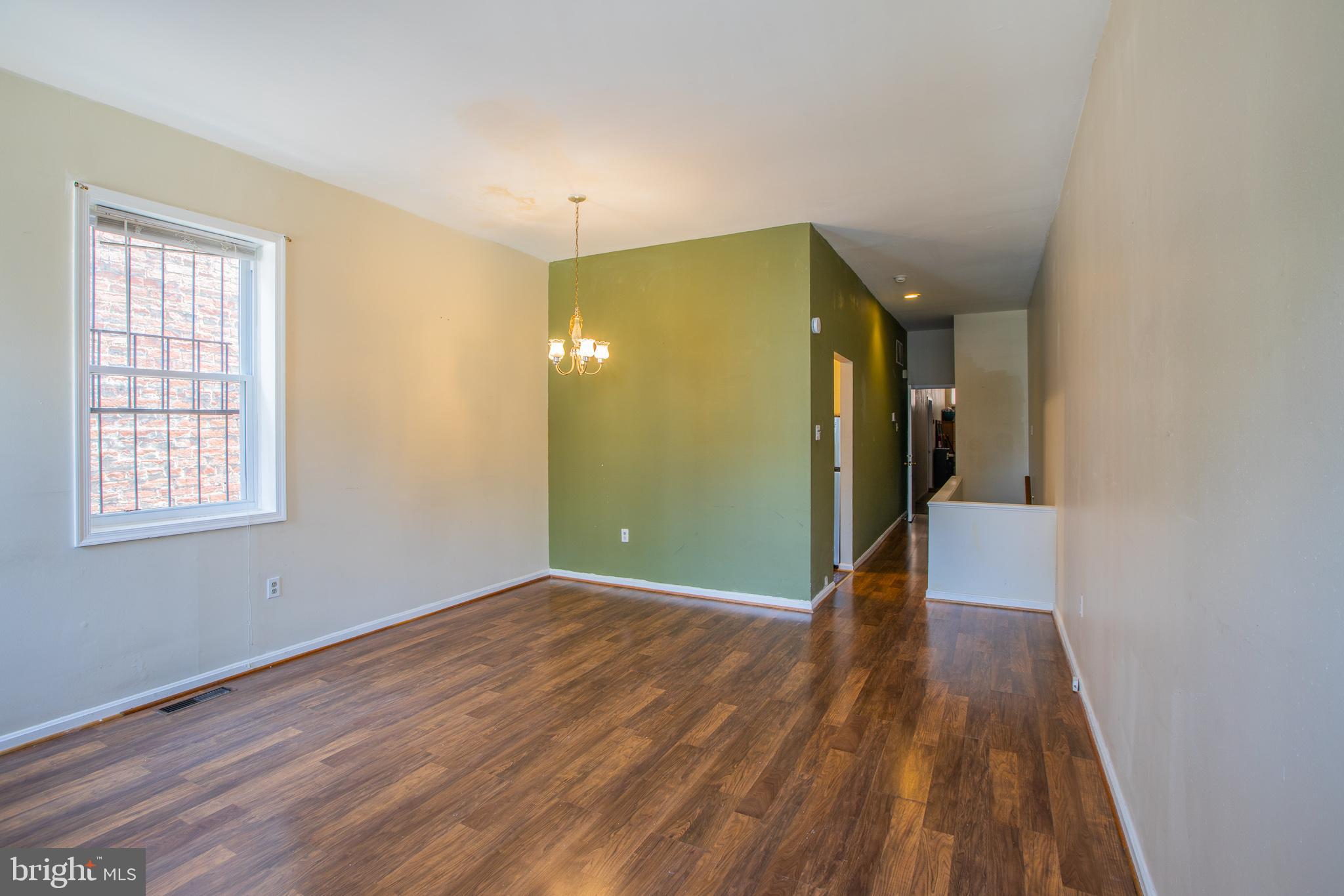 909 R Street Northwest, Unit B Washington, DC 20001 - Photo 6 of 17 a view of an empty room with wooden floor and a window