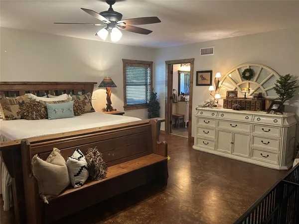 a dining room with furniture a chandelier and wooden floor