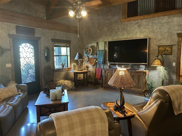 a living room with furniture windows and a fireplace