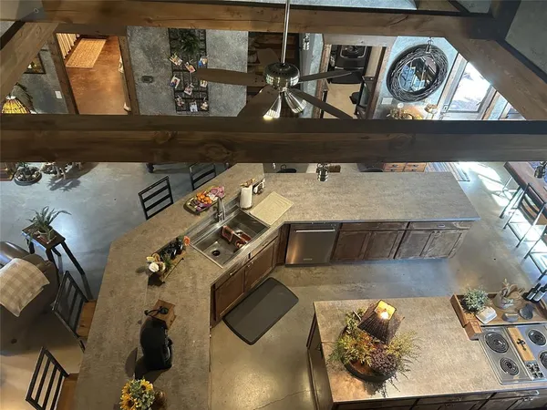 a kitchen with stainless steel appliances granite countertop a sink a stove and a wooden floors