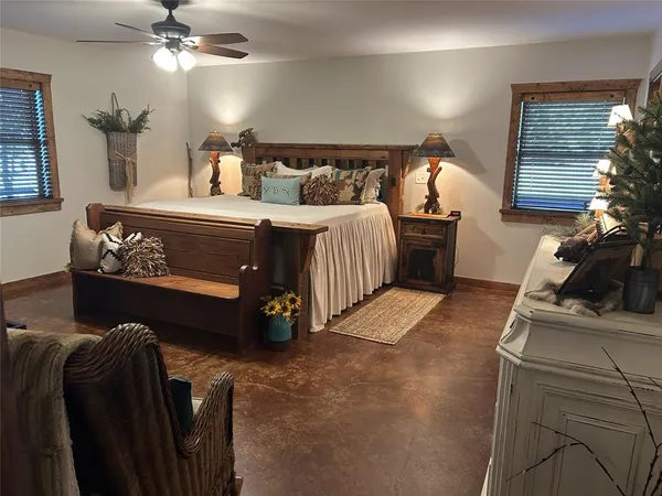 a bathroom with a granite countertop sink a toilet a mirror and shower