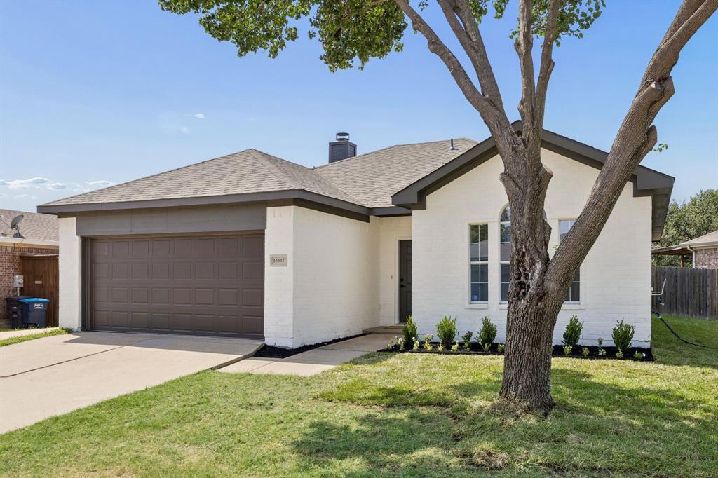 13347 Dove Ranch Road Fort Worth, TX 76262 - Photo 2 of 30 White brick exterior with dark trim and a brown garage door