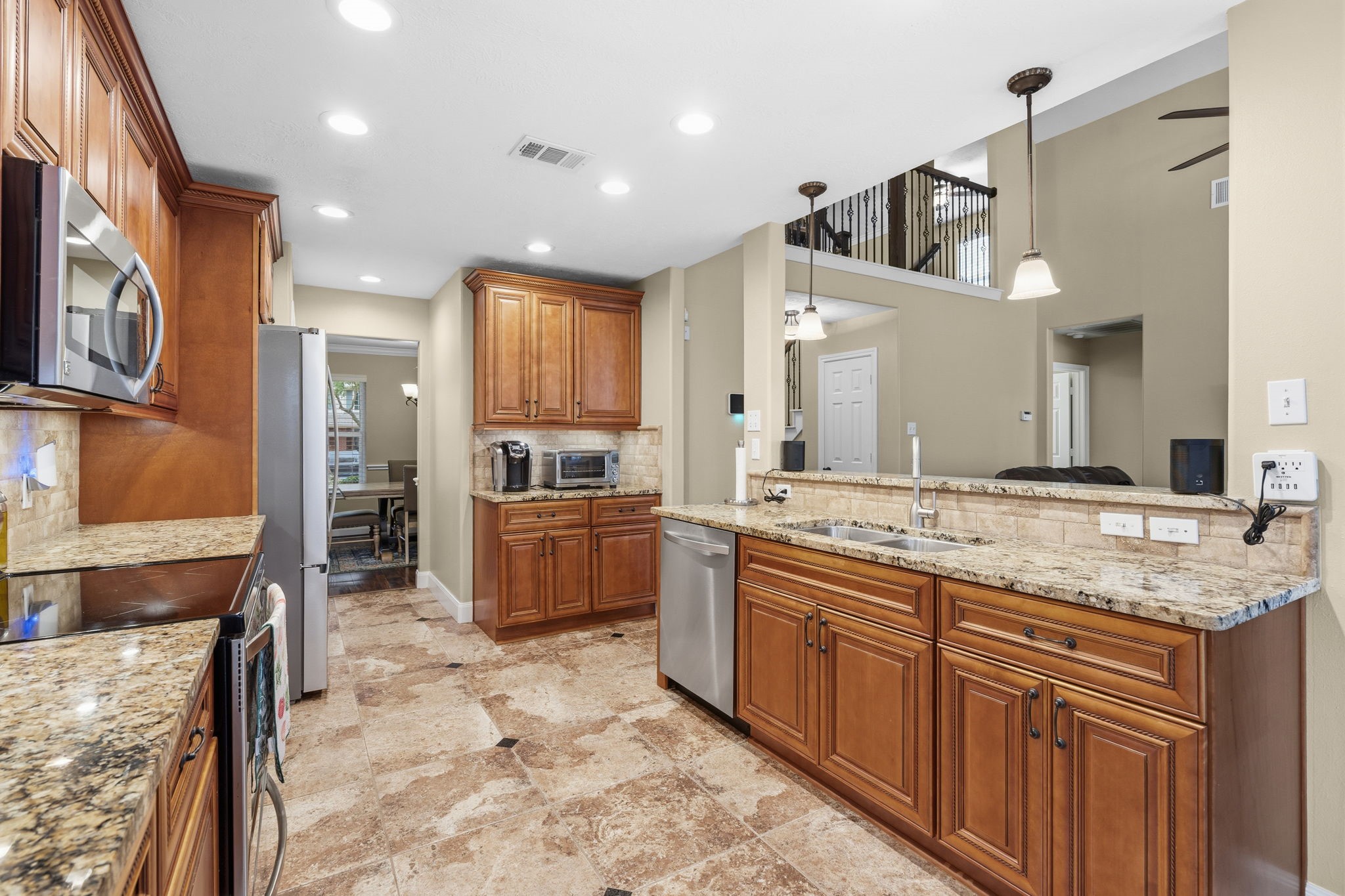 15319 Court Green Trail Cypress, TX 77433 - Photo 15 of 44 a large kitchen with stainless steel appliances kitchen island granite countertop a sink and cabinets