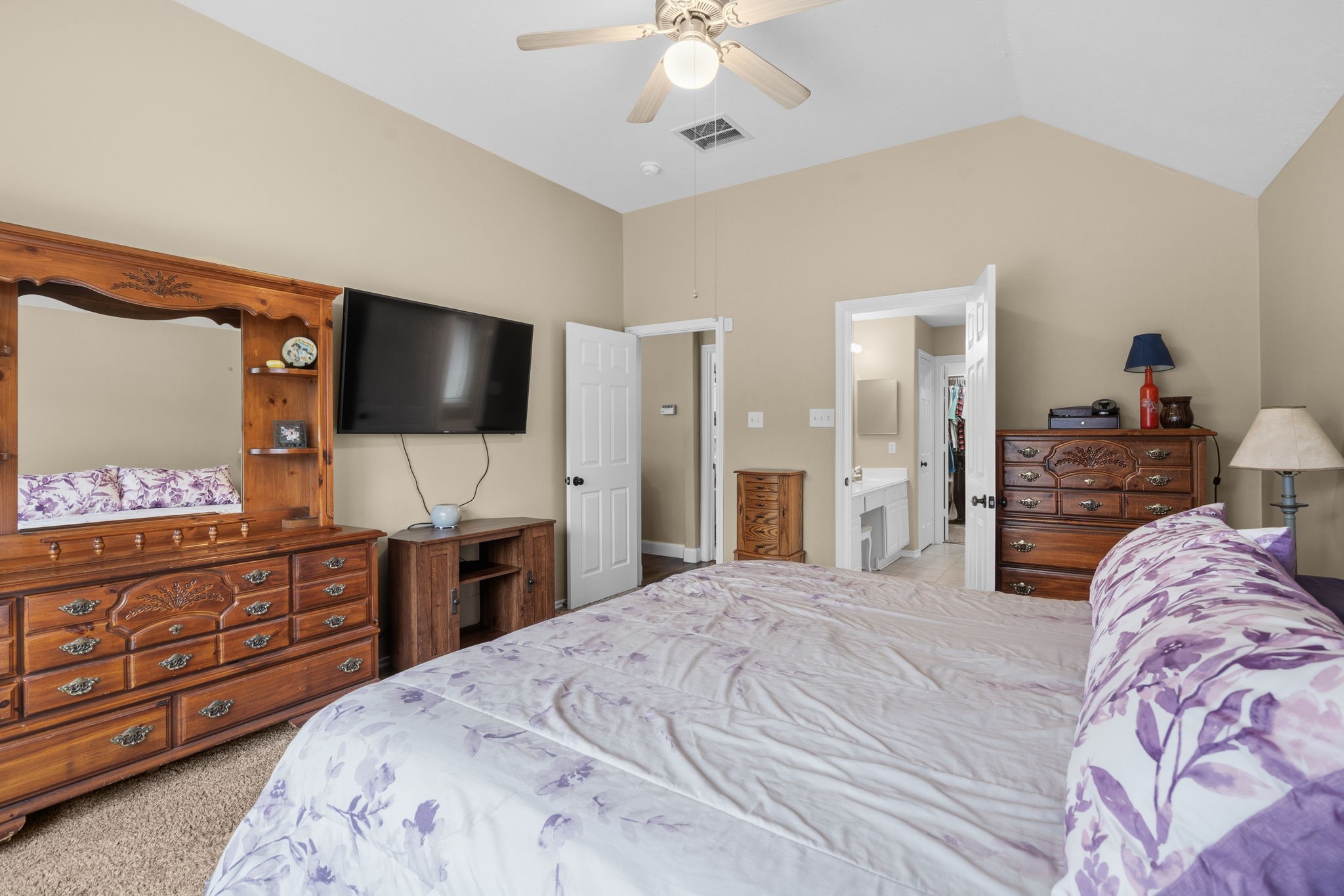 15319 Court Green Trail Cypress, TX 77433 - Photo 19 of 44 a bedroom with a bed and a flat screen tv