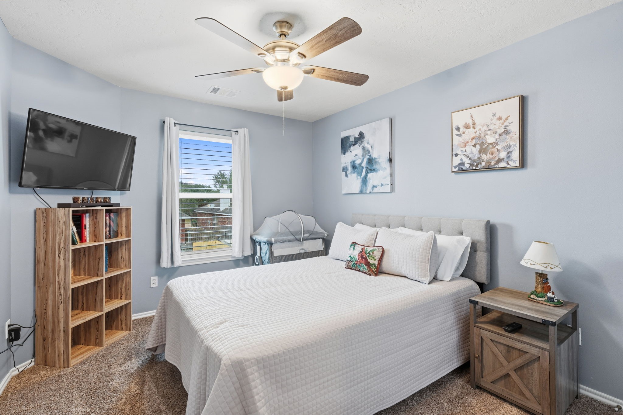 15319 Court Green Trail Cypress, TX 77433 - Photo 32 of 44 a bedroom with a bed and a flat screen tv