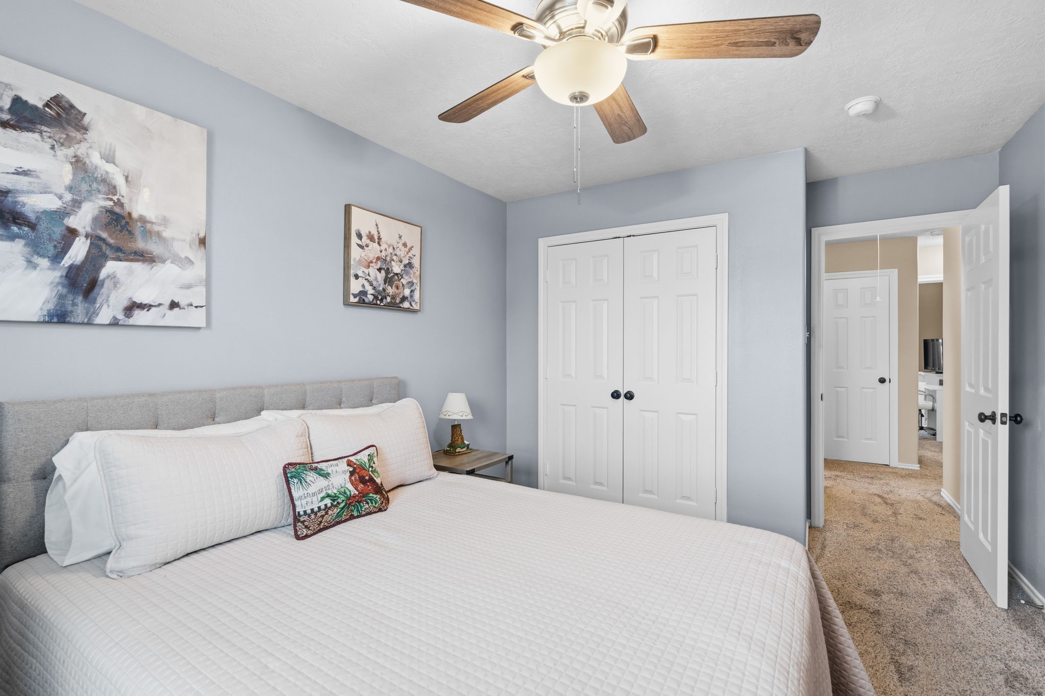 15319 Court Green Trail Cypress, TX 77433 - Photo 33 of 44 a bedroom with a bed and a chandelier