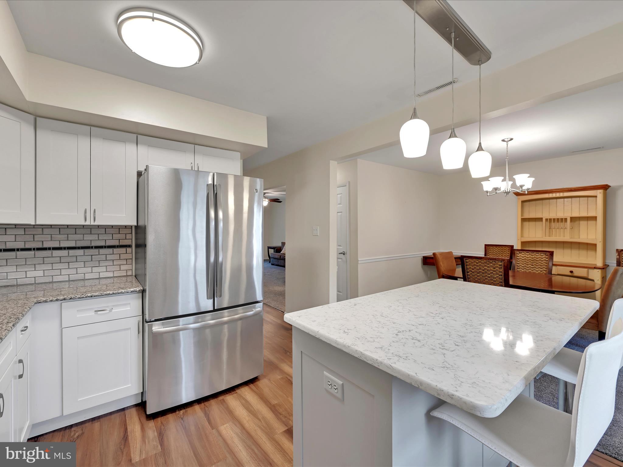 72 Azalea Way Reading, PA 19606 - Photo 11 of 27 a kitchen with stainless steel appliances granite countertop a refrigerator a sink dishwasher a stove and white cabinets with wooden floor
