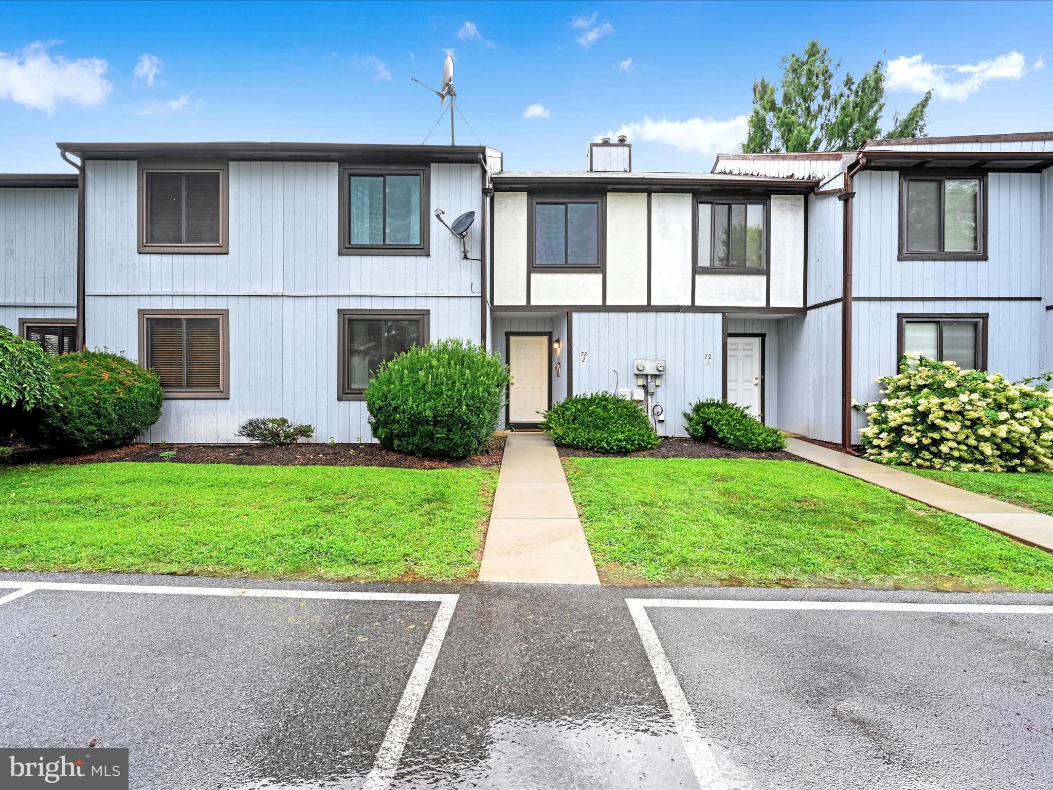 72 Azalea Way Reading, PA 19606 - Photo 2 of 27 a front view of a house with a yard and potted plants