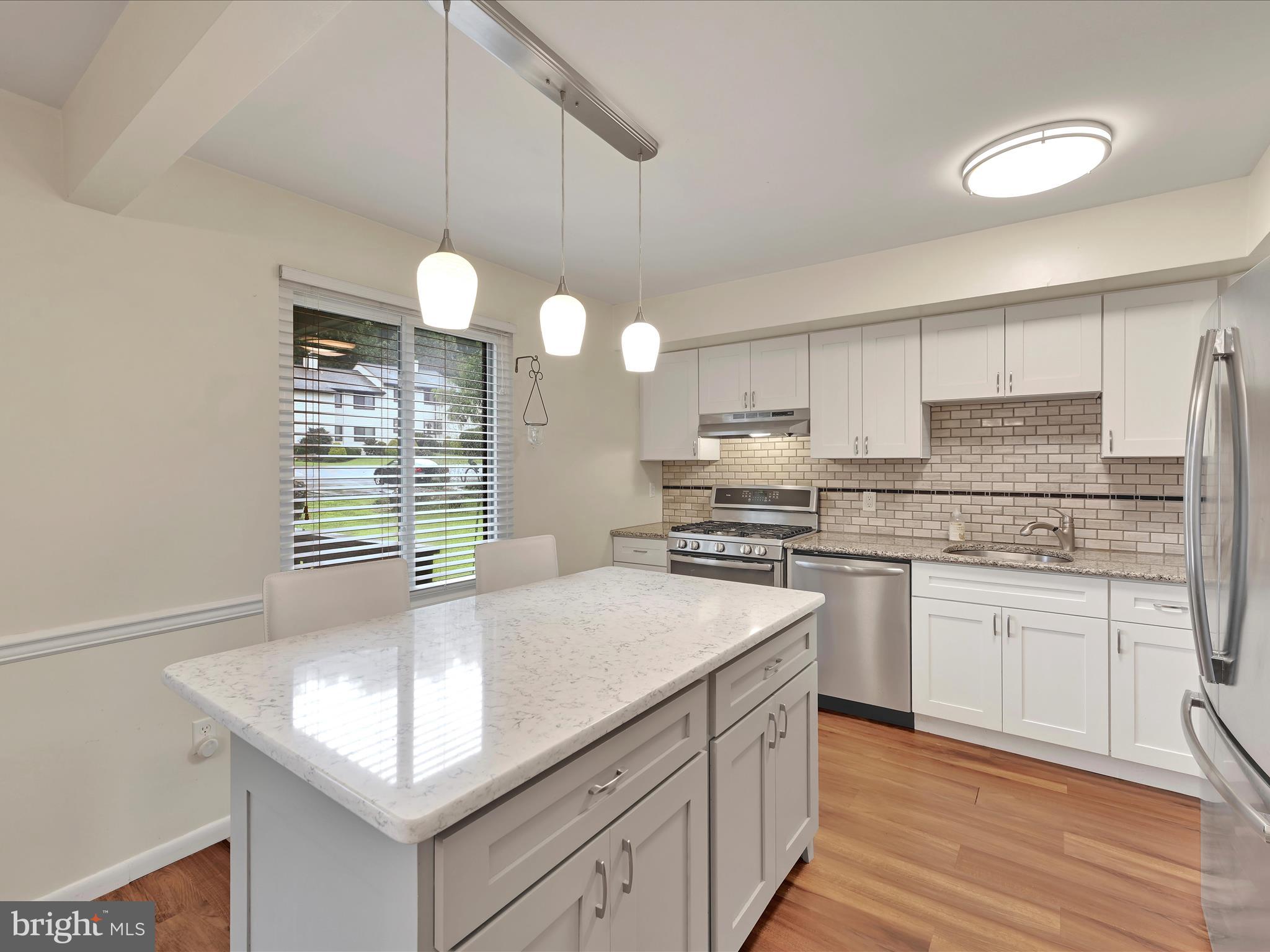 72 Azalea Way Reading, PA 19606 - Photo 9 of 27 a kitchen with kitchen island granite countertop a sink cabinets and stainless steel appliances