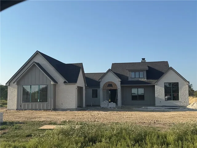 a view of house with yard