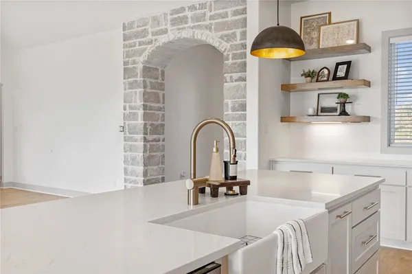 a kitchen with a sink a counter and a cabinets