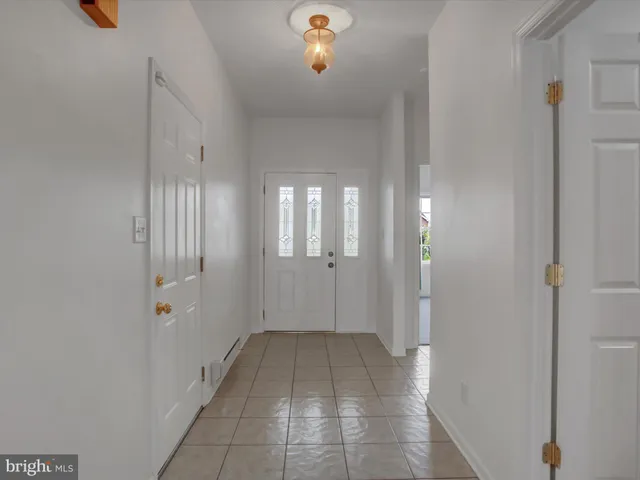 a view of a hallway with wooden shelves