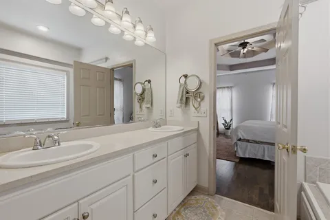 a en suite bathroom with a sink and a mirror