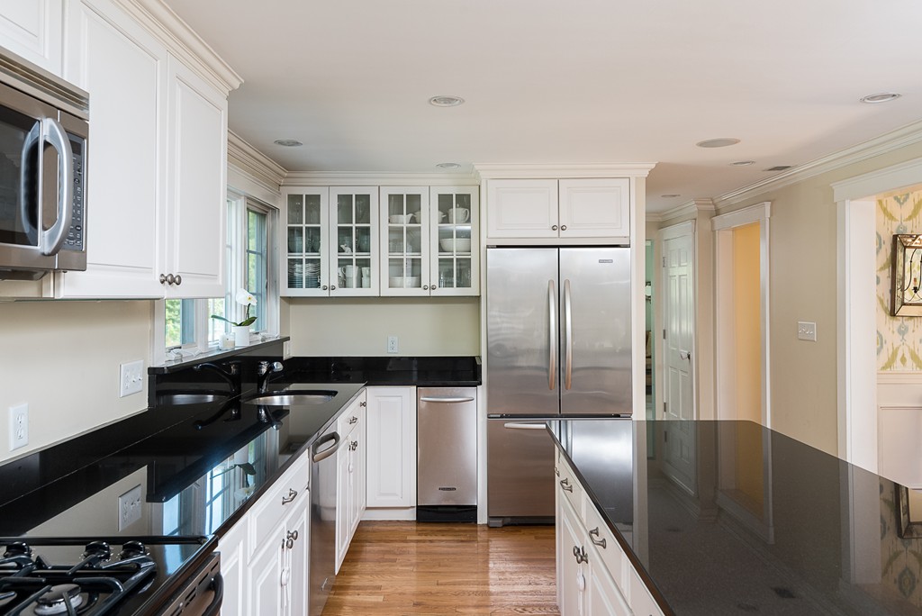 35 Stanford Drive Westwood, MA 02090 - Photo 11 of 29 a kitchen with stainless steel appliances granite countertop a sink a stove and refrigerator