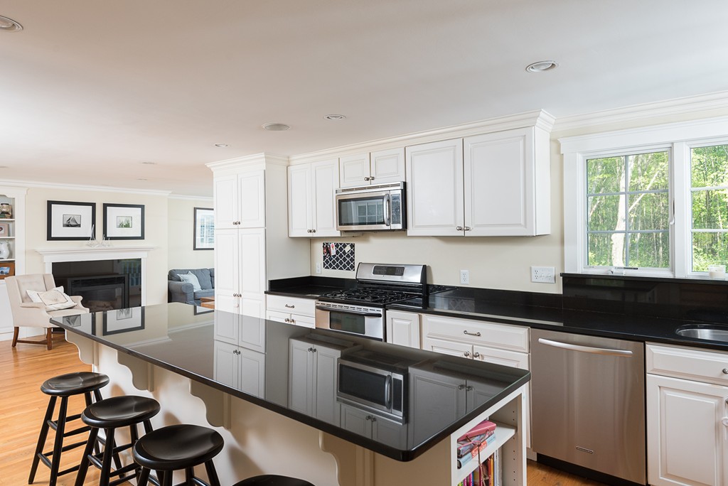 35 Stanford Drive Westwood, MA 02090 - Photo 9 of 29 a kitchen with granite countertop stainless steel appliances a stove sink and cabinets