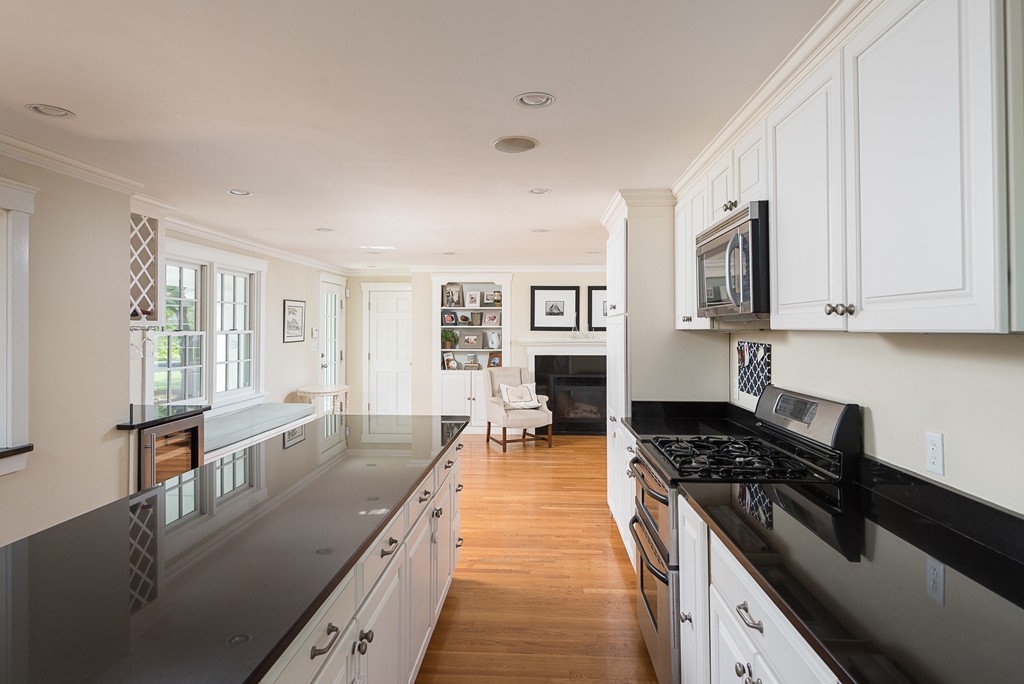 35 Stanford Drive Westwood, MA 02090 - Photo 10 of 29 a kitchen with granite countertop a stove top oven a sink a dining table and chairs
