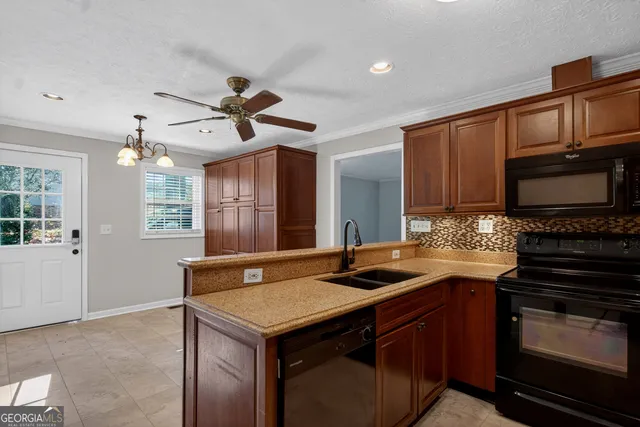 a kitchen with granite countertop a stove cabinets and microwave