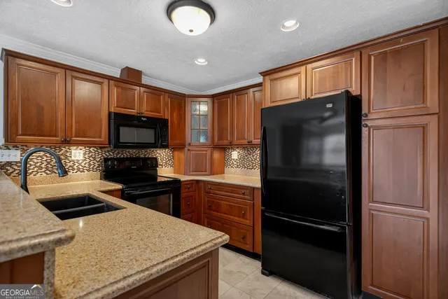 a kitchen with a refrigerator stove and sink