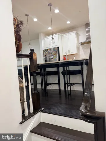 a large kitchen with a table and chairs