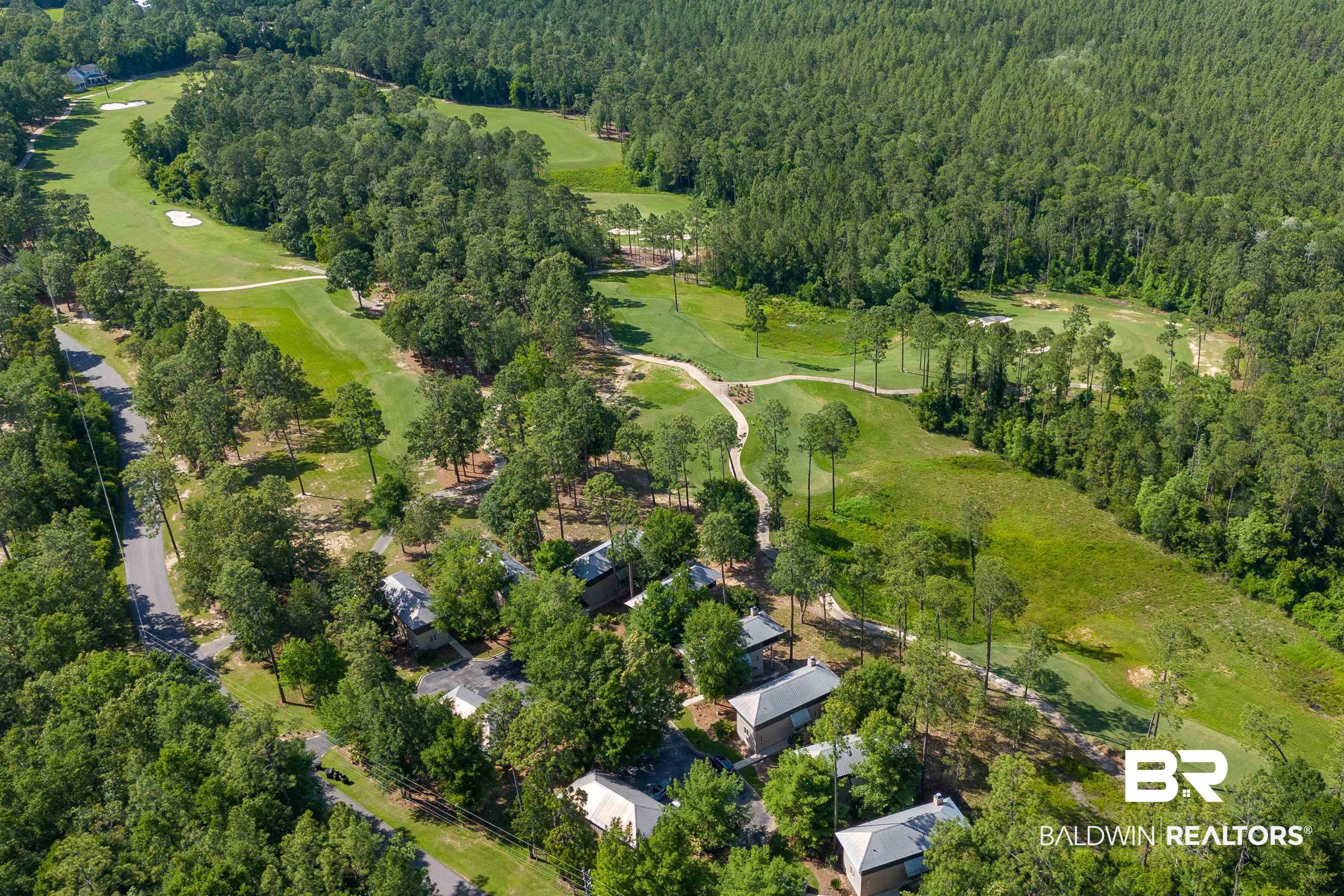 32760 Steelwood Ridge Road, Unit 7 Loxley, AL 36551 - Photo 63 of 64 Aerial view of property and surrounding area with a heavily wooded area and a local golf course