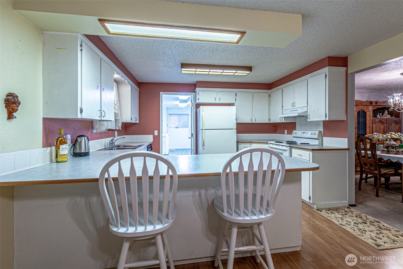 7505 Husky Way Southeast Lacey, WA 98503 - Photo 14 of 40 a kitchen with sink a window and chairs