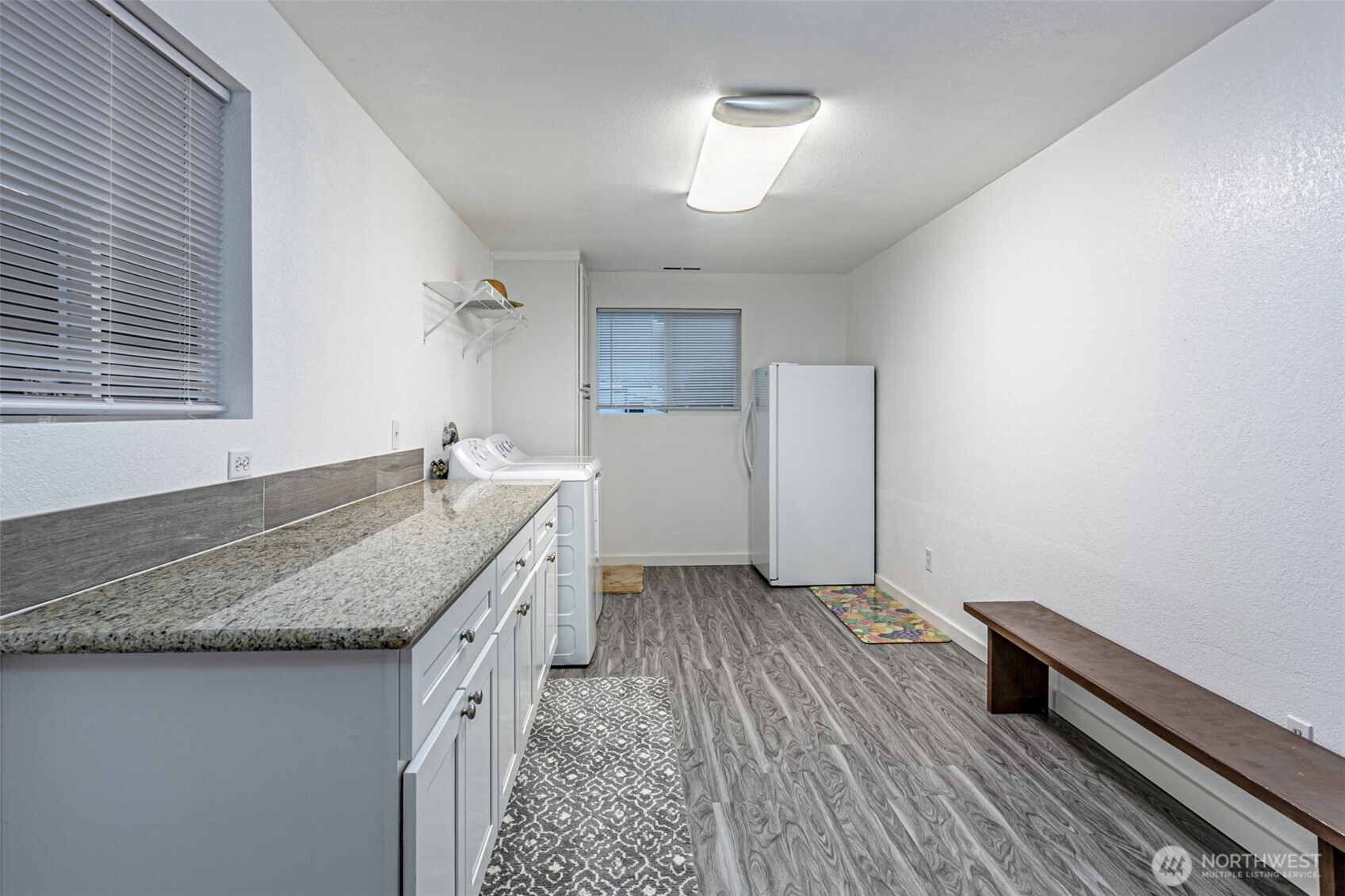 7505 Husky Way Southeast Lacey, WA 98503 - Photo 18 of 40 a bathroom with a granite countertop sink and a mirror