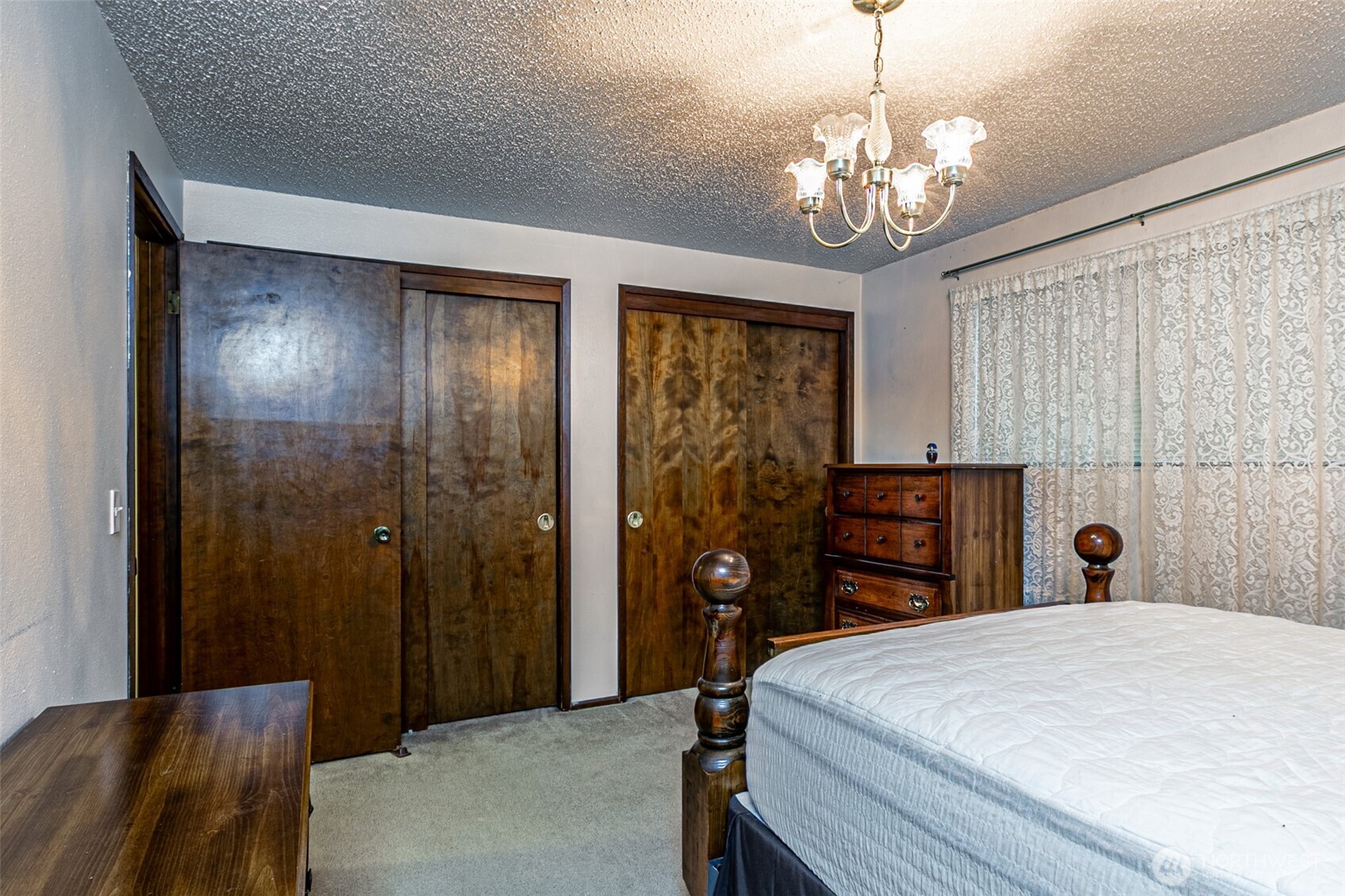 7505 Husky Way Southeast Lacey, WA 98503 - Photo 30 of 40 a bedroom with a bed and a chandelier