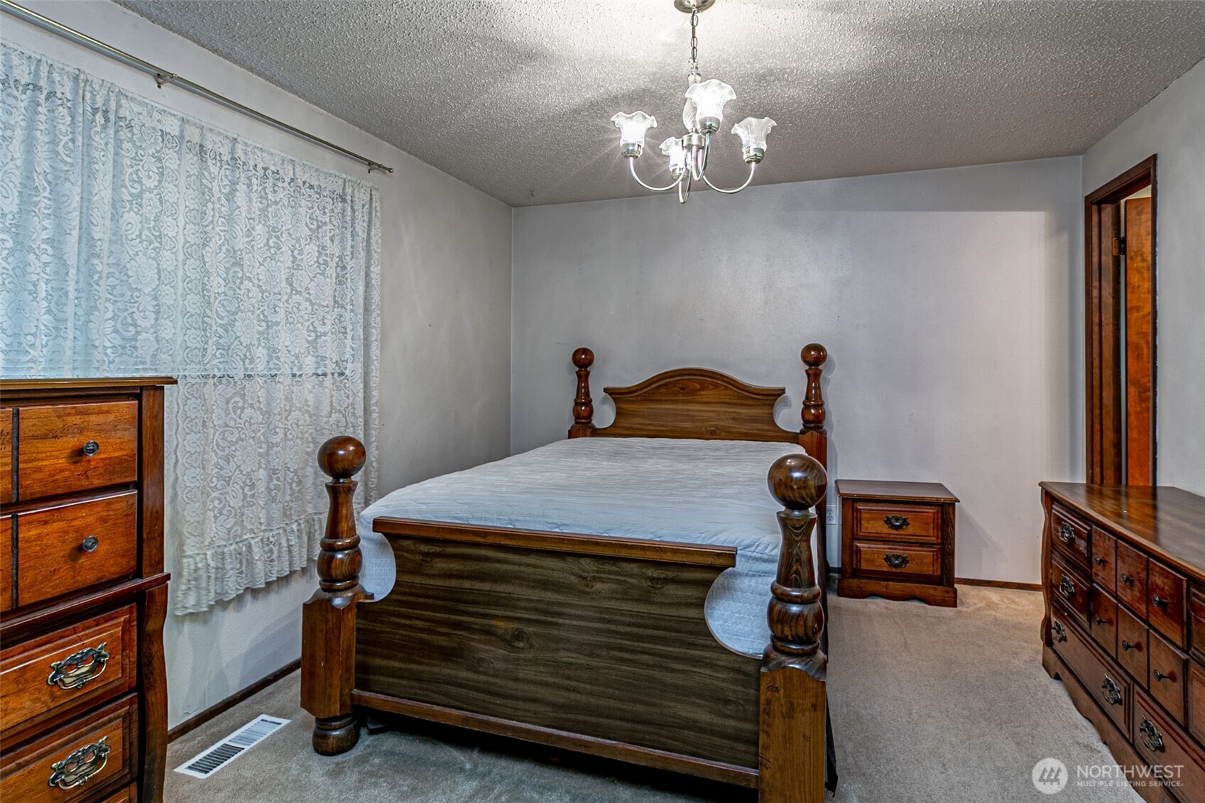 7505 Husky Way Southeast Lacey, WA 98503 - Photo 32 of 40 a bedroom with a bed and a chandelier