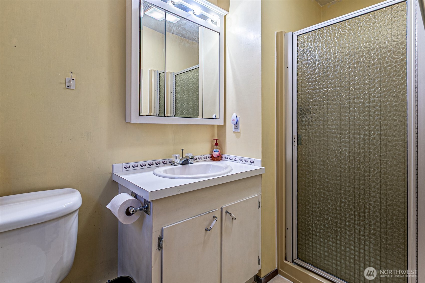 7505 Husky Way Southeast Lacey, WA 98503 - Photo 33 of 40 a bathroom with a sink toilet and mirror