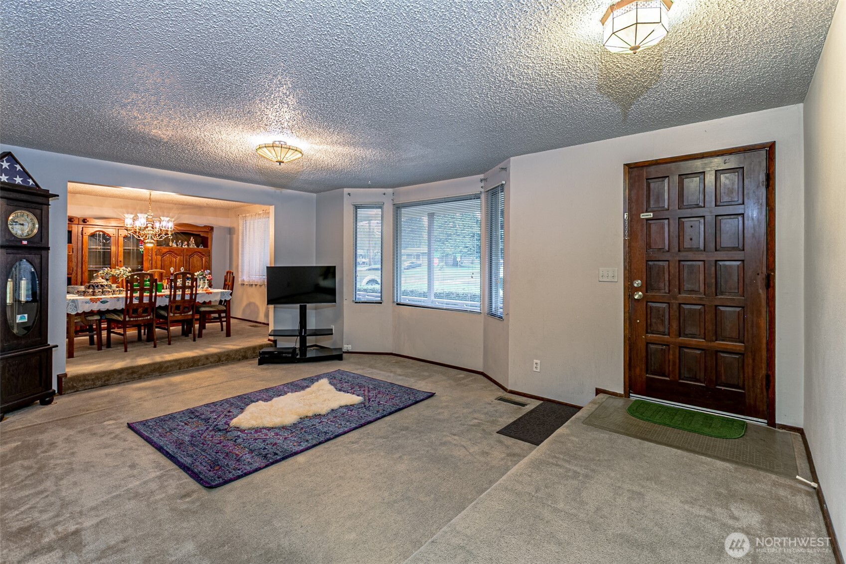 7505 Husky Way Southeast Lacey, WA 98503 - Photo 6 of 40 a living room with furniture gym equipment and a large window