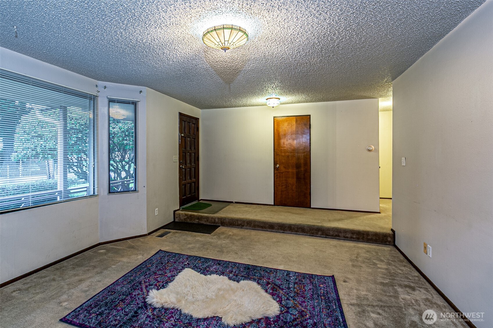 7505 Husky Way Southeast Lacey, WA 98503 - Photo 8 of 40 a view of an empty room with a rug