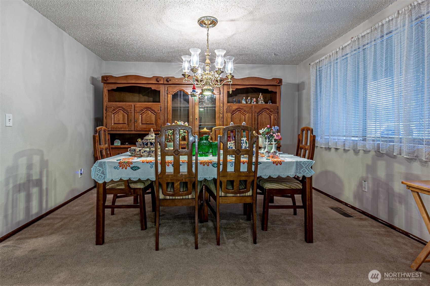 7505 Husky Way Southeast Lacey, WA 98503 - Photo 10 of 40 a view of a dining room with furniture and chandelier