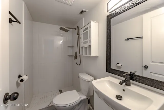 a view of a room with wooden floor staircase and a ceiling fan