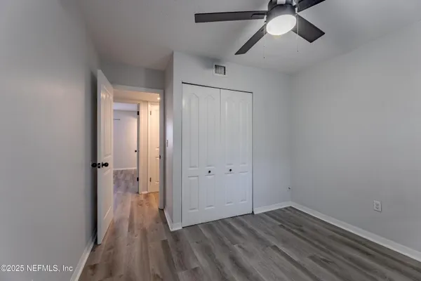 a view of a room with wooden floor and windows
