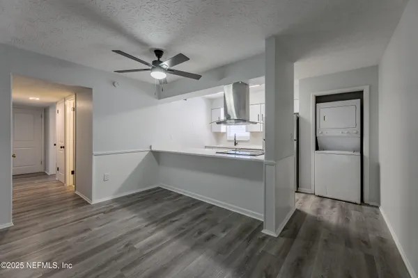 a view of a kitchen with wooden floor and a sink