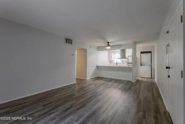 a view of a kitchen with wooden floor and a kitchen